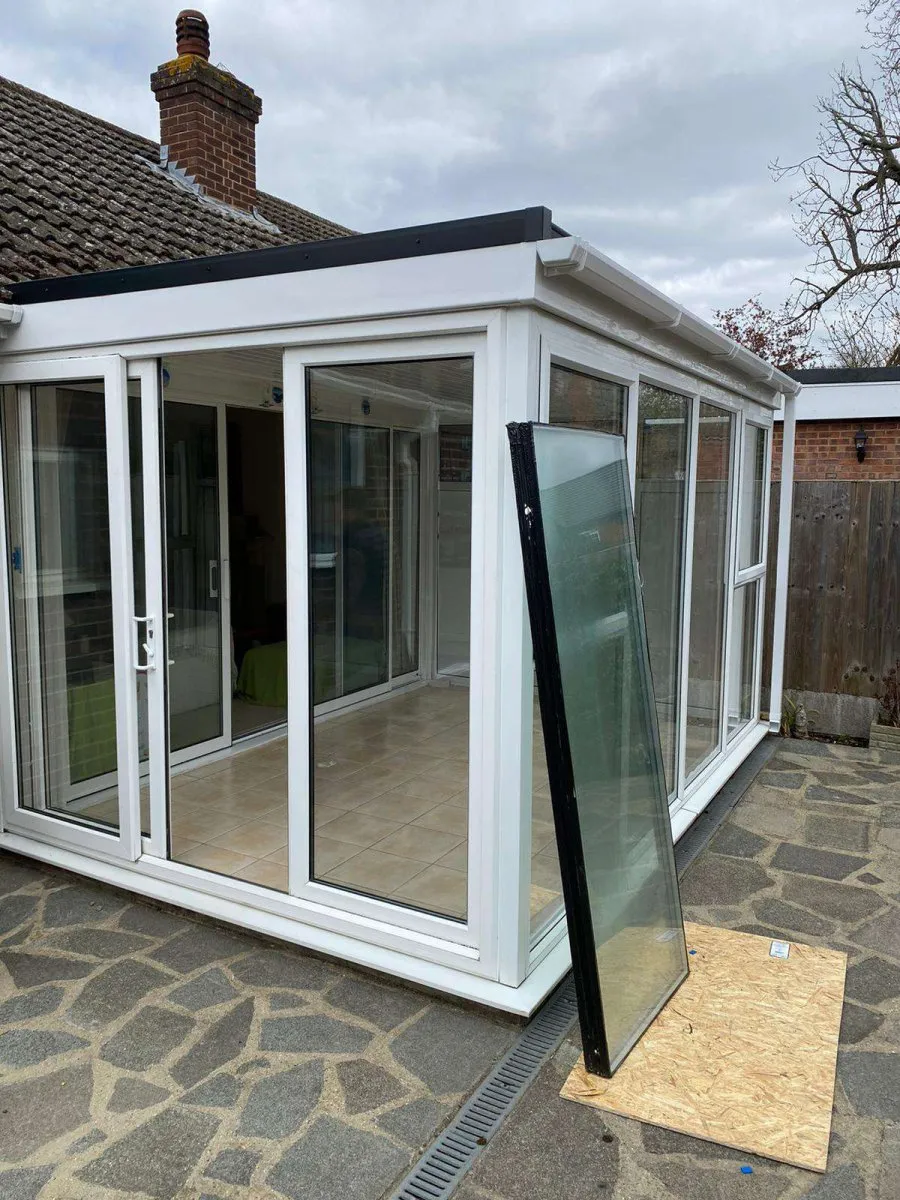 Sliding glass door temporarily boarded with plywood