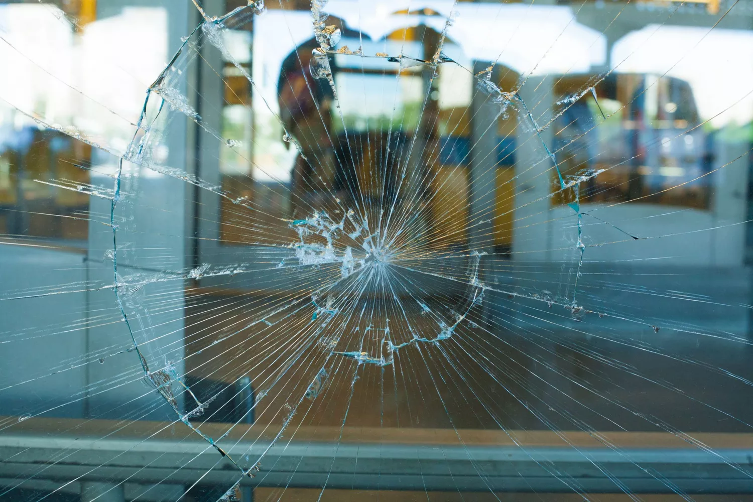 Large impact crack on a glass pane in a public building.