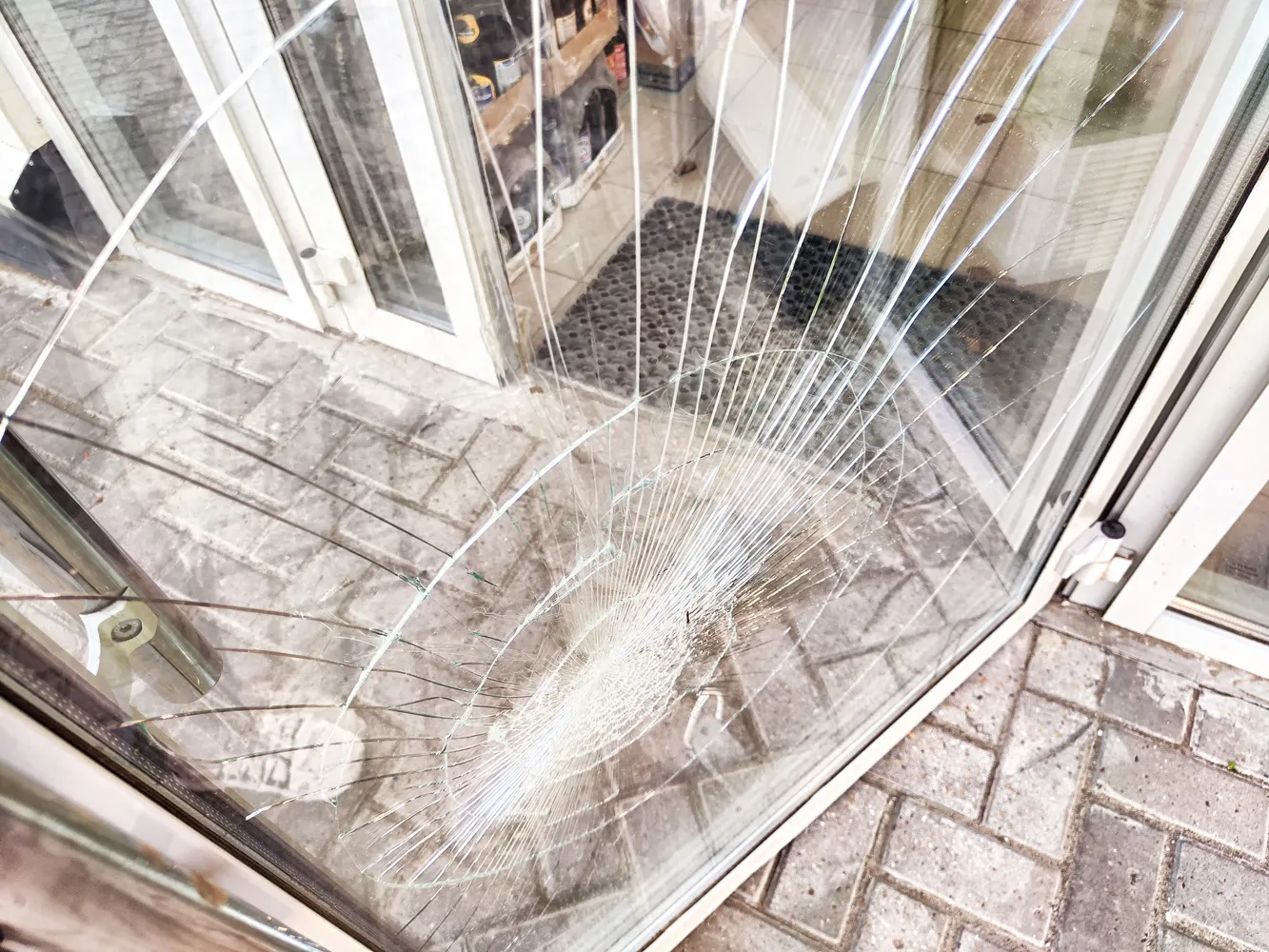 Broken glass door with visible cracks