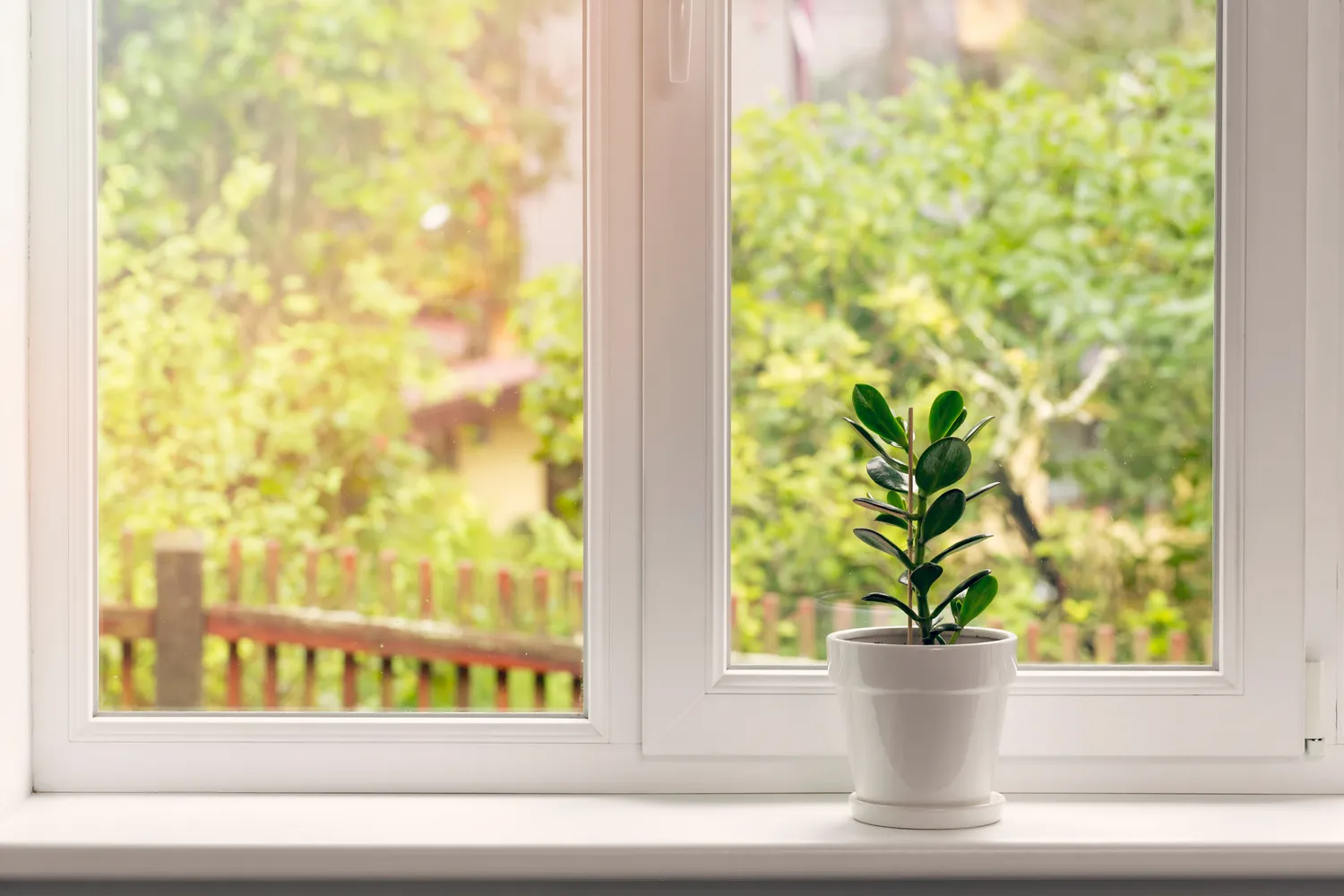 High-quality uPVC window installation by London glaziers with garden view, providing sound insulation and energy efficiency